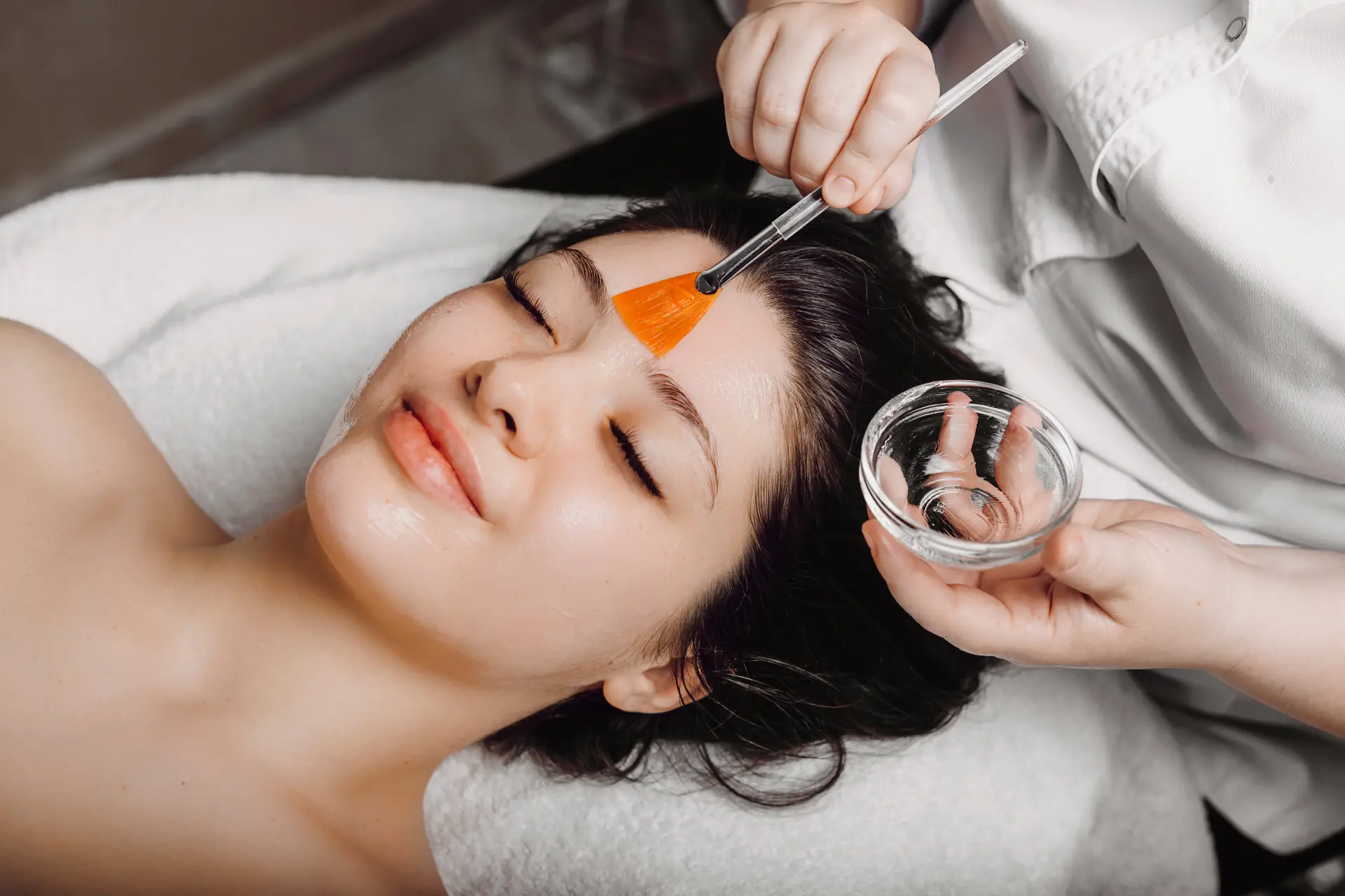 a woman receiving a face mask