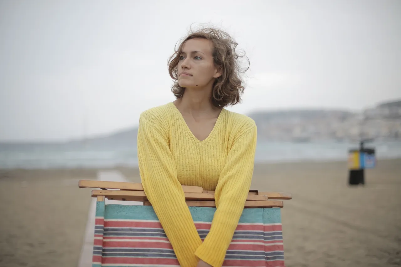 a woman leaning on a beach chair