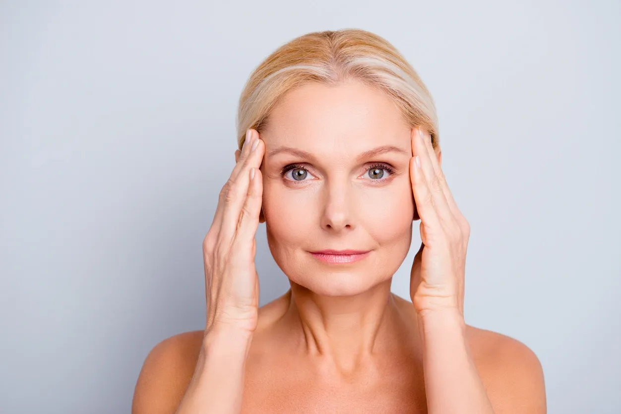 a woman touching her face