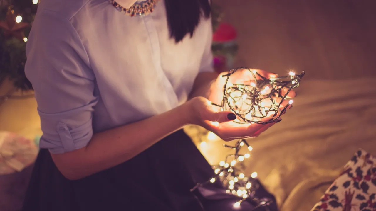 a person holding a string of lights