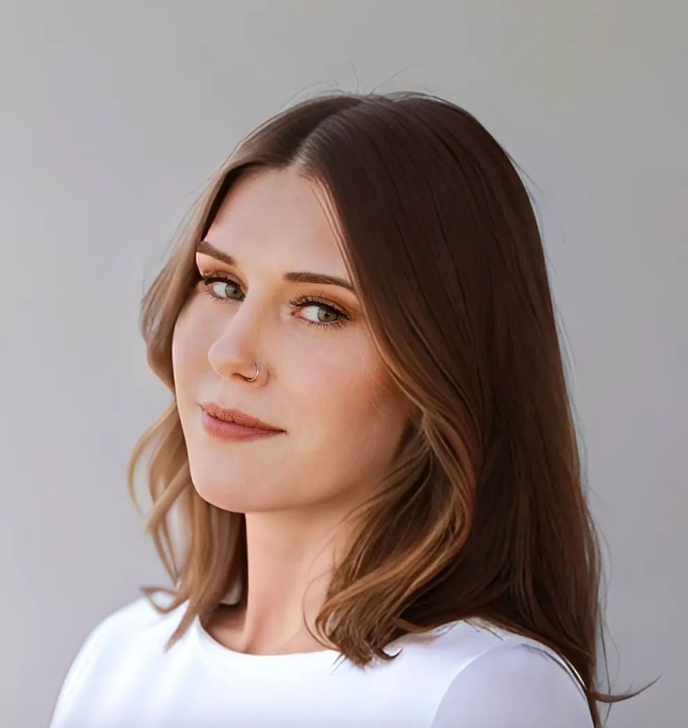 a woman with brown hair and a nose ring