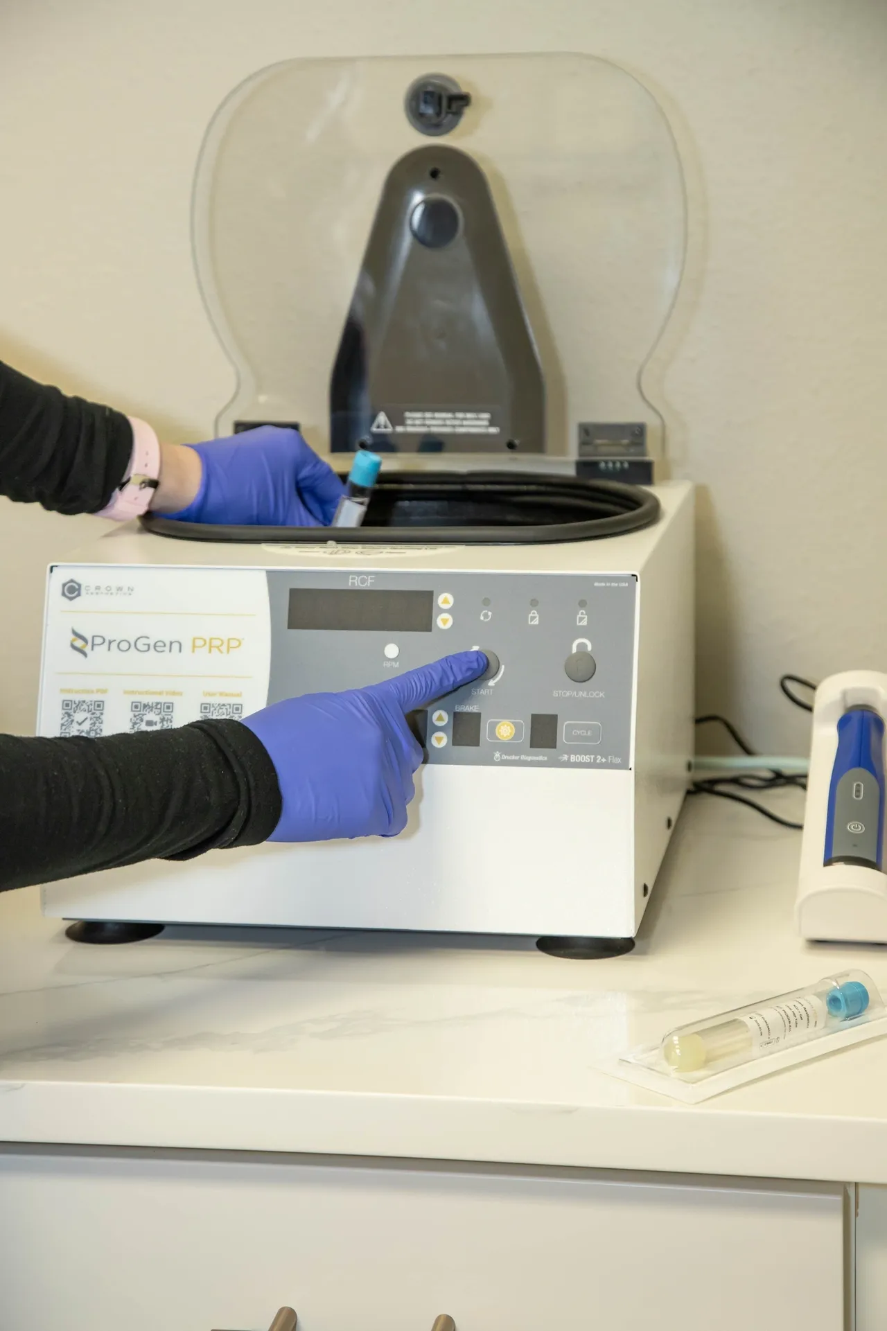 a person in gloves touching a device - before after microneedling progen prp