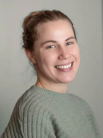 a woman smiling at the camera - kati