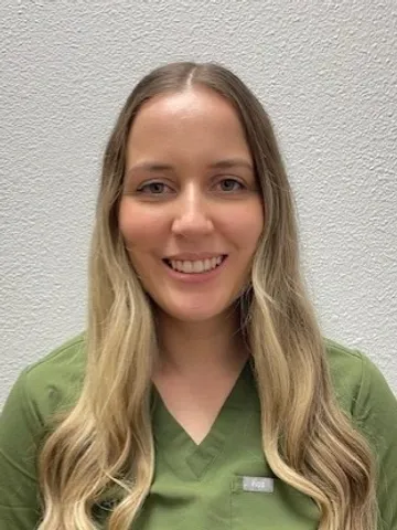 a woman in a green shirt - nicole