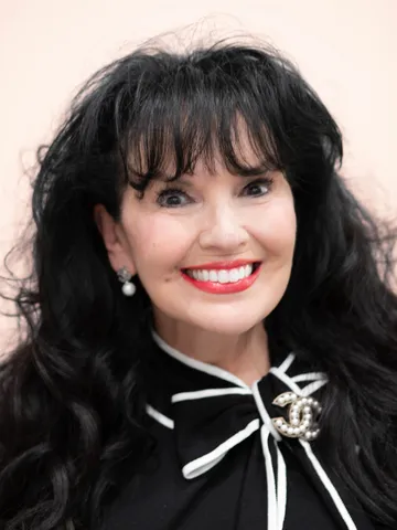 a woman with long black hair and a black and white striped shirt - yvone
